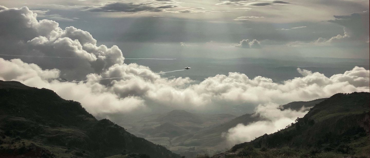 A sea of cloud seen from far above, lit from one side.
